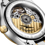 Close-up of the Longines Master Collection Moonphase, displaying its exposed mechanical movement with gold and silver accents, engraved branding, stainless steel case details, and the signature elegance of diamond hour markers.