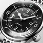 Close-up of the Longines Legend Diver watch with automatic movement, black dial, Arabic numerals, luminous markers, and a stainless steel bracelet.