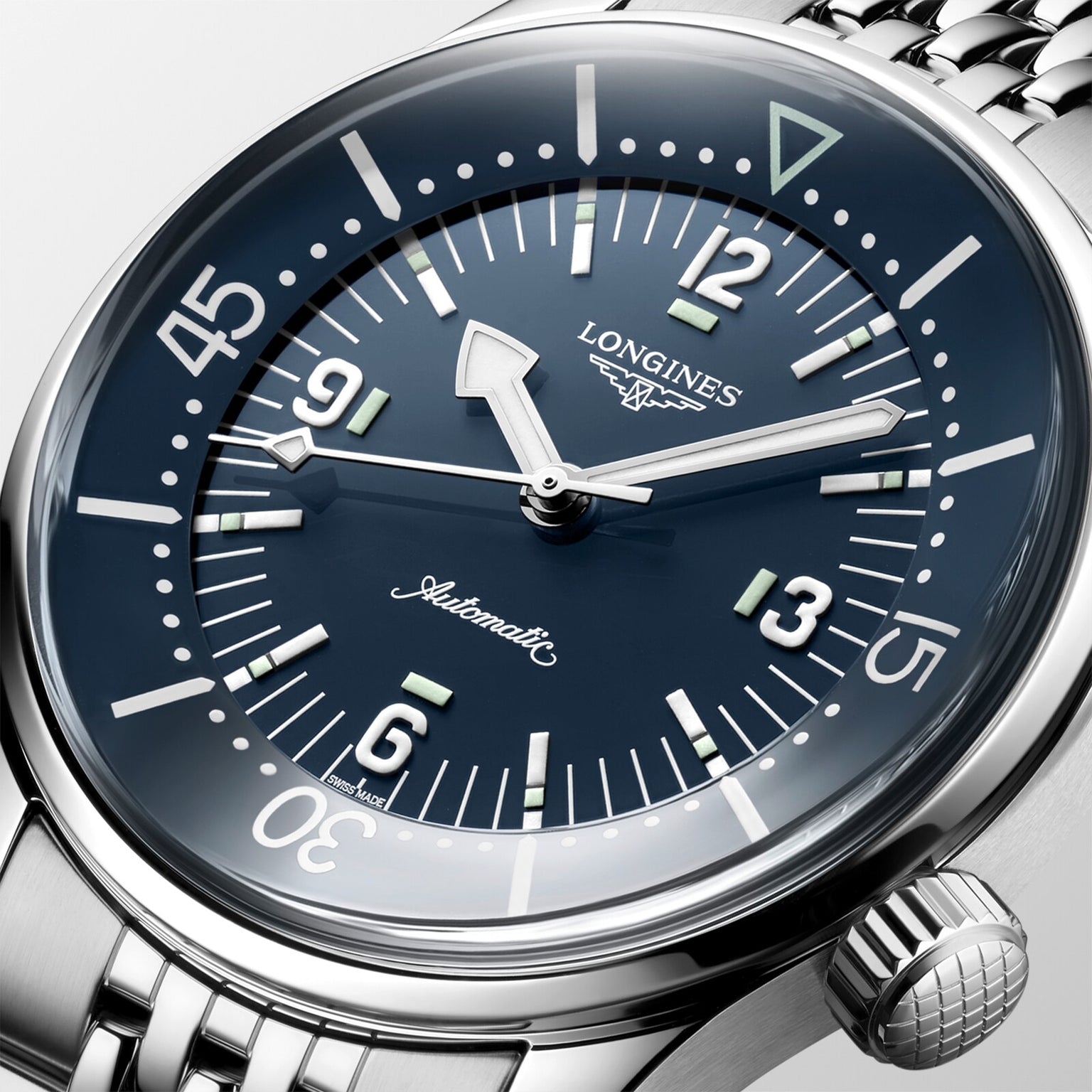 Close-up of the Longines Legend Diver watch, showcasing its black dial, luminous markers and hands, silver bezel, stainless steel bracelet, and automatic movement.
