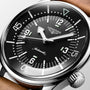 Close-up of the Longines Legend Diver, a vintage-inspired automatic watch with black dial, white numerals, luminous markers, and brown leather strap.