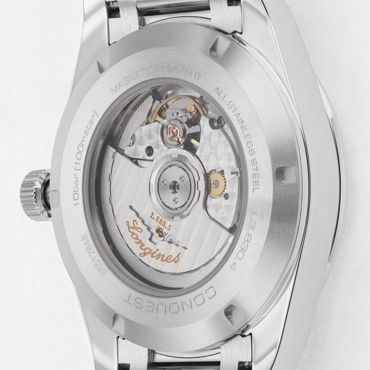 Close-up of the back of a Longines Conquest stainless steel watch, highlighting its automatic movement, engraved details, and transparent case back.