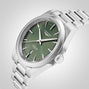 A Longines Conquest wristwatch with a green dial, Swiss Super-LumiNova hour markers, and a date window at 6 o’clock is shown angled on a light background.