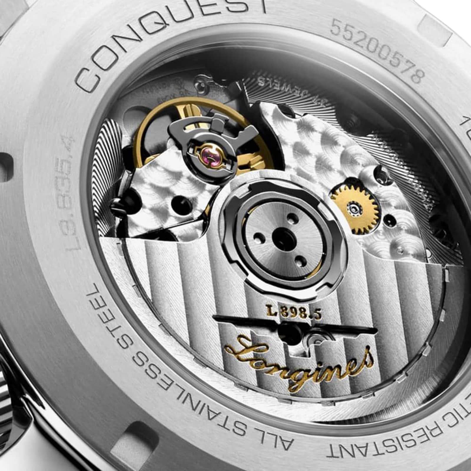 Close-up of the mechanical movement inside a Longines Conquest Chronograph, showcasing gears, engravings, and stainless steel parts that emphasize the elegance and performance of this renowned timepiece.