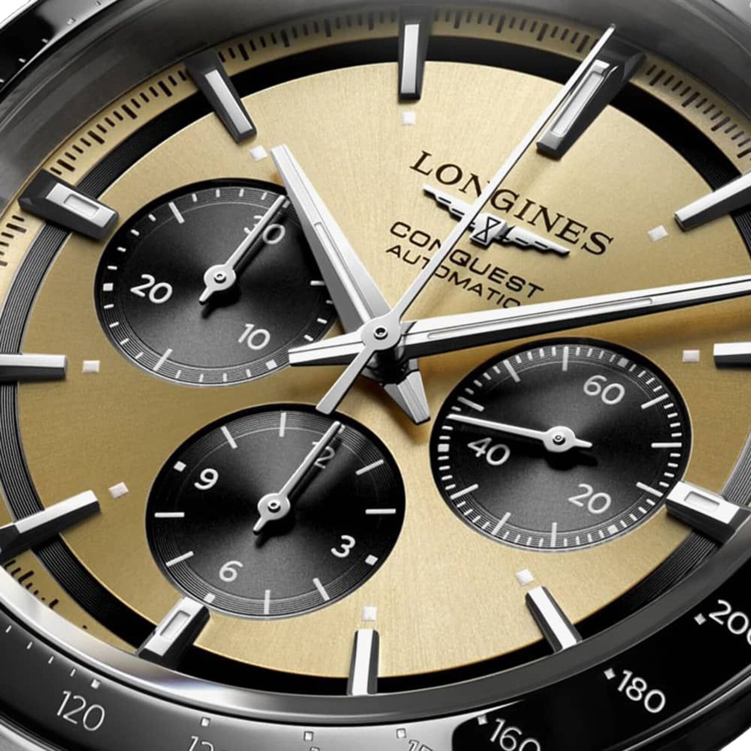 Close-up of the Longines Conquest Chronograph watch face, highlighting its gold and black dial, three subdials, silver hands, and detailed markers for an elegant look.