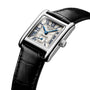 The Longines Mini DolceVita features a rectangular stainless steel case, black leather strap, white patterned dial with blue Roman numerals and hands, sapphire crystal, and is displayed angled on a white background.