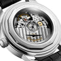 Close-up of the back of a Longines Conquest Heritage Central Power Reserve watch showing its automatic calibre movement, visible gears, and engraved details on the stainless steel case.
