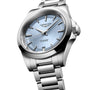 A Longines Conquest wristwatch featuring a silver case, light blue dial with silver hour markers, automatic movement, date display at 6 o’clock, and a stainless steel bracelet.