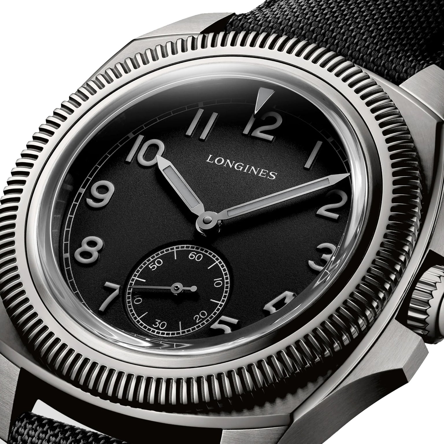 Close-up of the Longines Pilot Majetek Pioneer Edition, featuring a black dial with white numerals, small seconds at 6 o’clock, textured bezel, and black fabric strap—crafted in Grade 5 titanium with a silicon balance-spring.