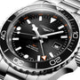 Close-up of a Longines Hydroconquest automatic watch featuring a black dial and bezel, orange GMT hand, date window, stainless steel case, and 300m water resistance.