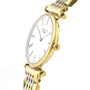 A Longines La Grande Classique de LONGINES wristwatch features a gold and silver design, white face, black Roman numerals, and two hands, elegantly photographed at an angle to showcase its sophistication.