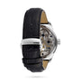 The Tissot T-Complication Squelette Mechanical is a wristwatch with a black leather strap, stainless steel buckle, and a transparent back displaying its intricate skeleton movement and visible gears.