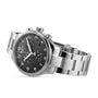 The Tissot Chrono XL Classic wristwatch features Swiss technology, a stainless steel case, black dial with three subdials, date window, and silver hour markers, all stylishly angled.