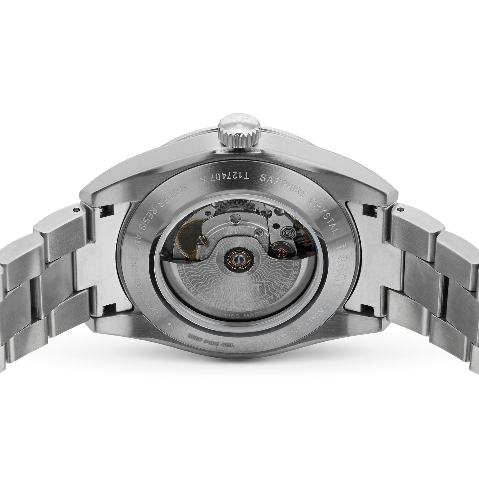 The image displays the back of the Tissot Gentleman Powermatic 80 Silicium, featuring a stainless steel case and a transparent window that reveals its intricate Powermatic 80 mechanical movement.