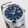 The Tissot Gentleman Powermatic 80 Silicium features a stainless steel case, blue dial, silver hour markers, and a date display set to the 8th—an elegant wristwatch from the Tissot collection.