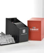 A Tissot Classic Dream watch box with branded packaging, a black display stand, informational inserts, and a red Tissot box—ideal for showcasing the elegance and style of your Classic Dream timepiece.
