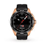 A Tissot T-Touch Connect Solar watch featuring a black dial, rose gold antimagnetic titanium case, and black rubber strap, with multiple digital functions shown on its display and the word Welcome visible.