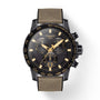 The Tissot Supersport Chrono features a black dial with gold markers, three subdials, Swiss quartz movement, a date window at 6 o’clock, and a khaki fabric strap.