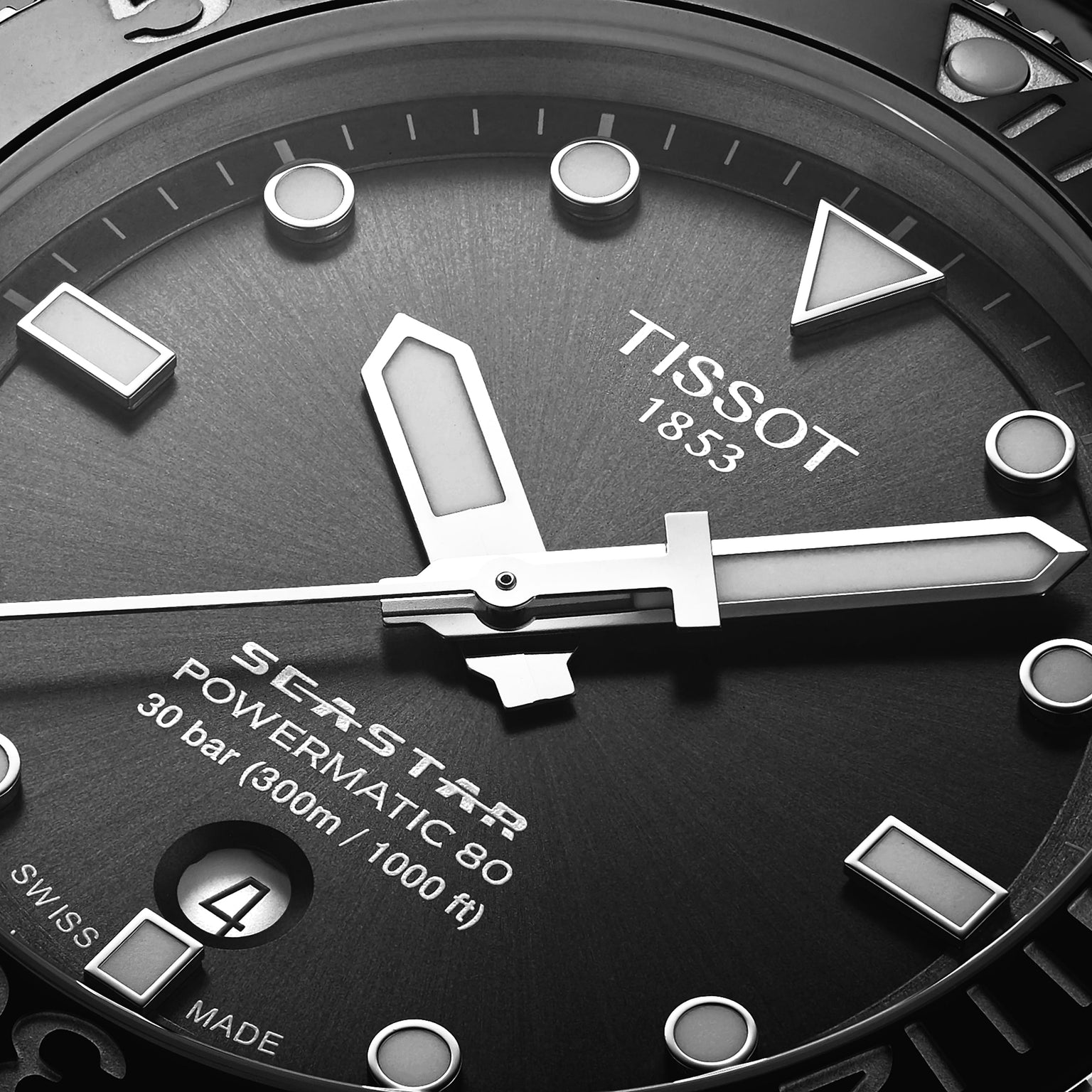 Close-up of the Tissot Seastar 1000 Powermatic 80 watch face, showing hands, markers, date window, and brand logo on a textured dial with Powermatic 80 movement.