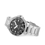 The Tissot Seastar 1000 Powermatic 80, a stainless steel diver’s watch with a black dial and bezel, silver hour markers, and a metal link bracelet, is displayed on a white background.