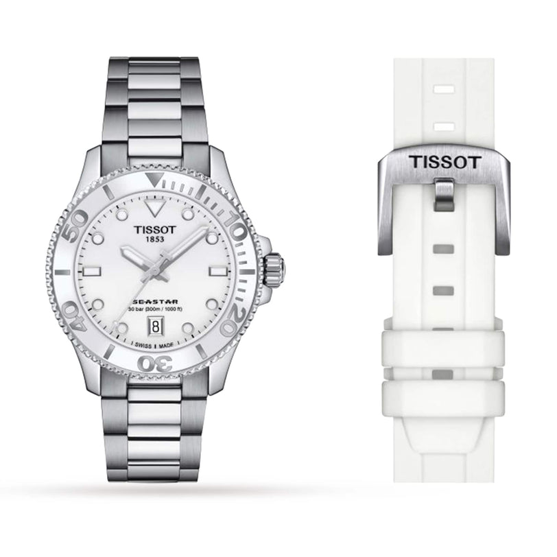 A Tissot Seastar 1000 watch with a silver metal band, displayed alongside a white interchangeable rubber strap.