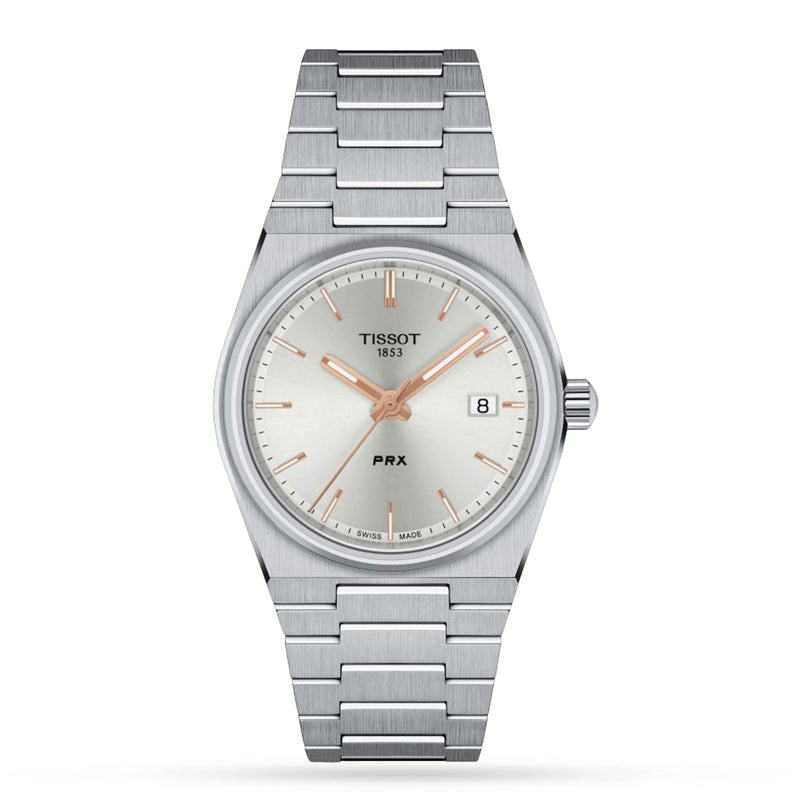 A Tissot PRX wristwatch featuring a stainless steel case, silver dial, gold hour markers, Swiss quartz movement, date display at 3 o’clock, and a metal link bracelet is photographed against a white background.