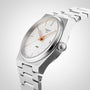 The Tissot PRX is a stainless steel wristwatch with a silver dial, gold hour markers, and bracelet, featuring Swiss quartz movement, showcased on a plain light background.
