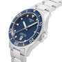 The Tissot Seastar 1000 is a stainless steel divers watch featuring a blue dial, rotating bezel, date display, luminous markers, and water resistance for underwater reliability. Shown here at an angled view.