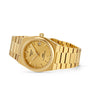 The Tissot PRX Powermatic 80 wristwatch features a gold-PVD case, textured waffle dial, date display at 3 o’clock, and matching gold bracelet, shown on a white background.