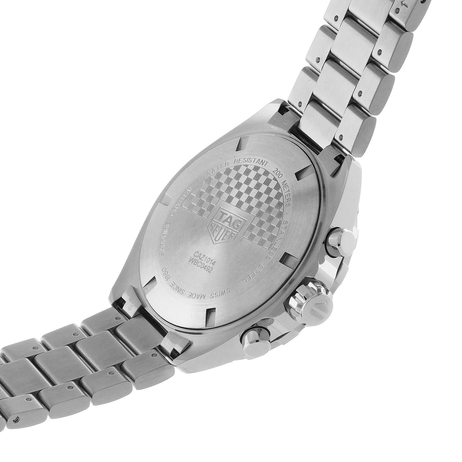 The image shows the back of a stainless steel TAG Heuer Formula 1 Chronograph, featuring engravings of the brand logo, model details, water resistance, and information about its precise quartz movement.