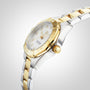 The TAG Heuer Aquaracer Date, a two-tone 18K gold and stainless steel wristwatch with white dial and gold bezel, is displayed at an angle on a light gradient background.