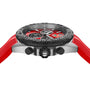 A close-up side view of the TAG Heuer Formula 1 Chronograph, showcasing its stainless steel case, red strap, black bezel, and red dial with chronograph subdials.