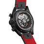 Back view of the TAG Heuer Autavia Flyback Chronometer, featuring its exposed calibre 02 Flyback movement, black case, red leather strap, and engraved caseback details.