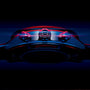 A close-up, low-angle view of the TAG Heuer Special Edition Carrera Chronograph x Porsche wristwatch with illuminated buttons and crown set against a dark, blue-black background.