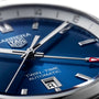 Close-up of the TAG Heuer Carrera Twin-Time, featuring a blue dial, silver markers and hands, red-tipped GMT hand, date at 6 o’clock, GMT function, and powered by the Calibre 7 automatic movement.