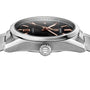 A close-up side view of the TAG Heuer Carrera Date watch, featuring a stainless steel case, black dial, rose gold hour markers and hands, and a branded crown.