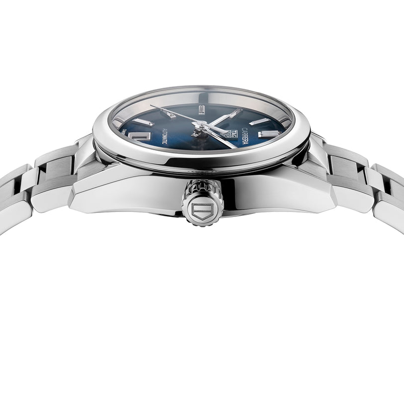 A close-up side view of the TAG Heuer Carrera Date stainless steel watch with a blue sunray dial and metal bracelet, highlighting the crown and part of the case.