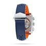 A close-up view of the back of the TAG Heuer Special Edition Monaco Gulf, featuring a blue perforated leather strap with orange lining and a silver clasp, showcasing the automatic Heuer 02 movement.