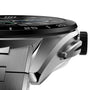 Close-up of the TAG Heuer Connected Calibre E4: a silver wristwatch with avant-garde design, metal band, case, black bezel with numbers, and side crown.