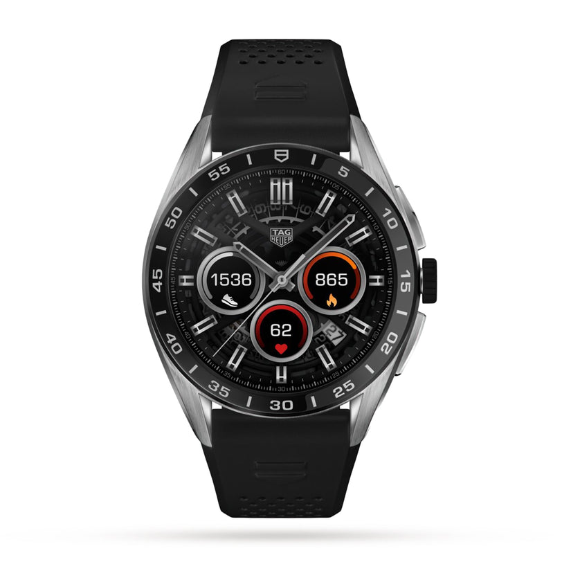 The TAG Heuer Connected Calibre E4 is a black luxury smartwatch with a round display showing step count, calories, and heart rate. It features silver accents and a sporty black perforated strap.