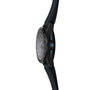 The TAG Heuer Connected Calibre E4 Porsche Edition wristwatch, featuring a round face, blue-accented side buttons, and a black strap with blue stitching, is displayed from a side angle.