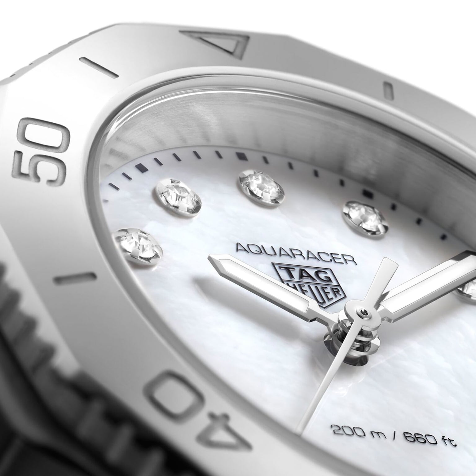 Close-up of the TAG Heuer Aquaracer Professional 200 sports watch face featuring diamond hour markers, a white dial, and a silver bezel with 40- and 50-minute markers, set in a polished stainless steel case.