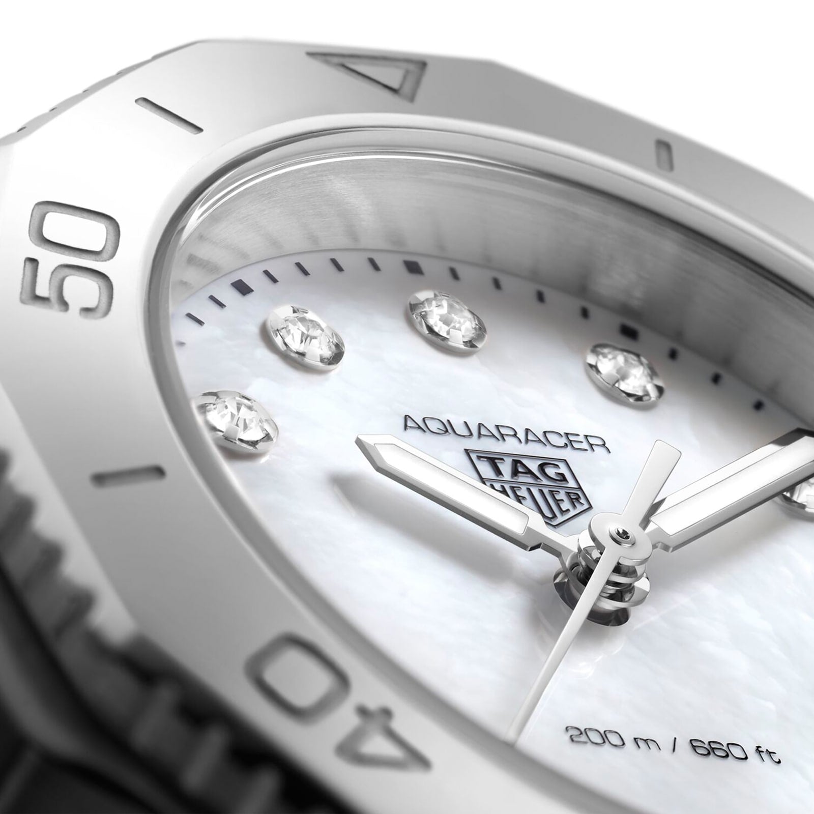 Close-up of the TAG Heuer Aquaracer Professional 200 sports watch face featuring diamond hour markers, a white dial, and a silver bezel with 40- and 50-minute markers, set in a polished stainless steel case.