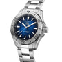 The TAG Heuer Aquaracer Professional 200 Date is a silver diving watch with a blue dial, silver hour markers, date at 6 o’clock, and a stainless steel bracelet and case.