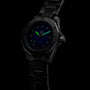 The TAG Heuer Aquaracer Professional 200 Date sports watch features a black stainless steel case and band, with a luminescent green minute hand and blue hour hand, shown against a dark background.