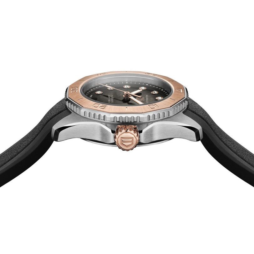 A close-up side view of the TAG Heuer Aquaracer Professional 200 Date featuring a black strap, silver case, rose gold bezel, diamond indexes, and a crown with an engraved logo.