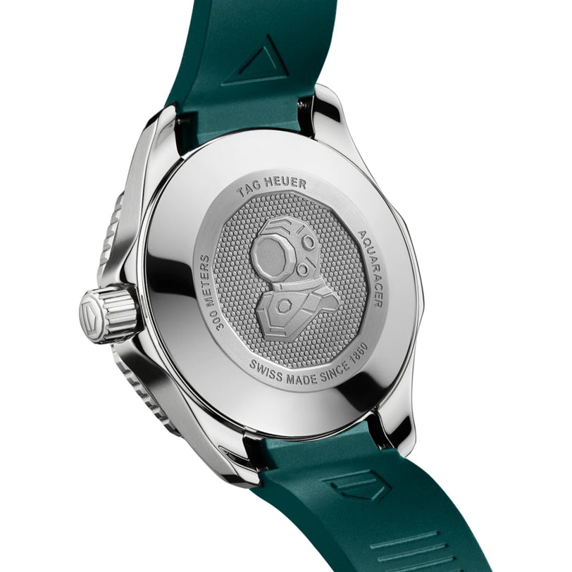 The image shows the back of a TAG Heuer Aquaracer Professional 300 Date watch with a green strap, featuring an engraved diving helmet and labeled 300 METERS SWISS MADE SINCE 1860.