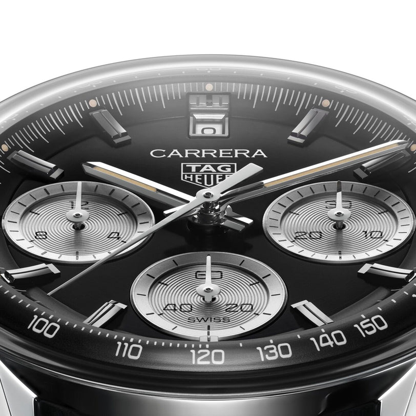 Close-up of a TAG Heuer Carrera Chronograph watch face with three subdials, silver markers, a black tachymeter bezel, and a sleek black leather strap.