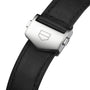 Close-up of the TAG Heuer Carrera Chronograph’s black leather strap with a silver clasp engraved with a geometric logo, showcasing its automatic movement.