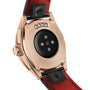 Close-up of the back of TAG Heuer Connected Calibre E4 Golden Bright Edition, showcasing a rose gold case, black sensor area, and bold red leather strap—a fusion of modern tech with classic TAG Heuer elegance.