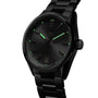 The TAG Heuer Carrera Date is a black metal wristwatch featuring a round face, green luminescent hands and hour markers, and a date display at 6 o’clock—offering enduring style and elegance.